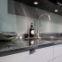 Black profile handle in light kitchen with dark worktop and chrome details